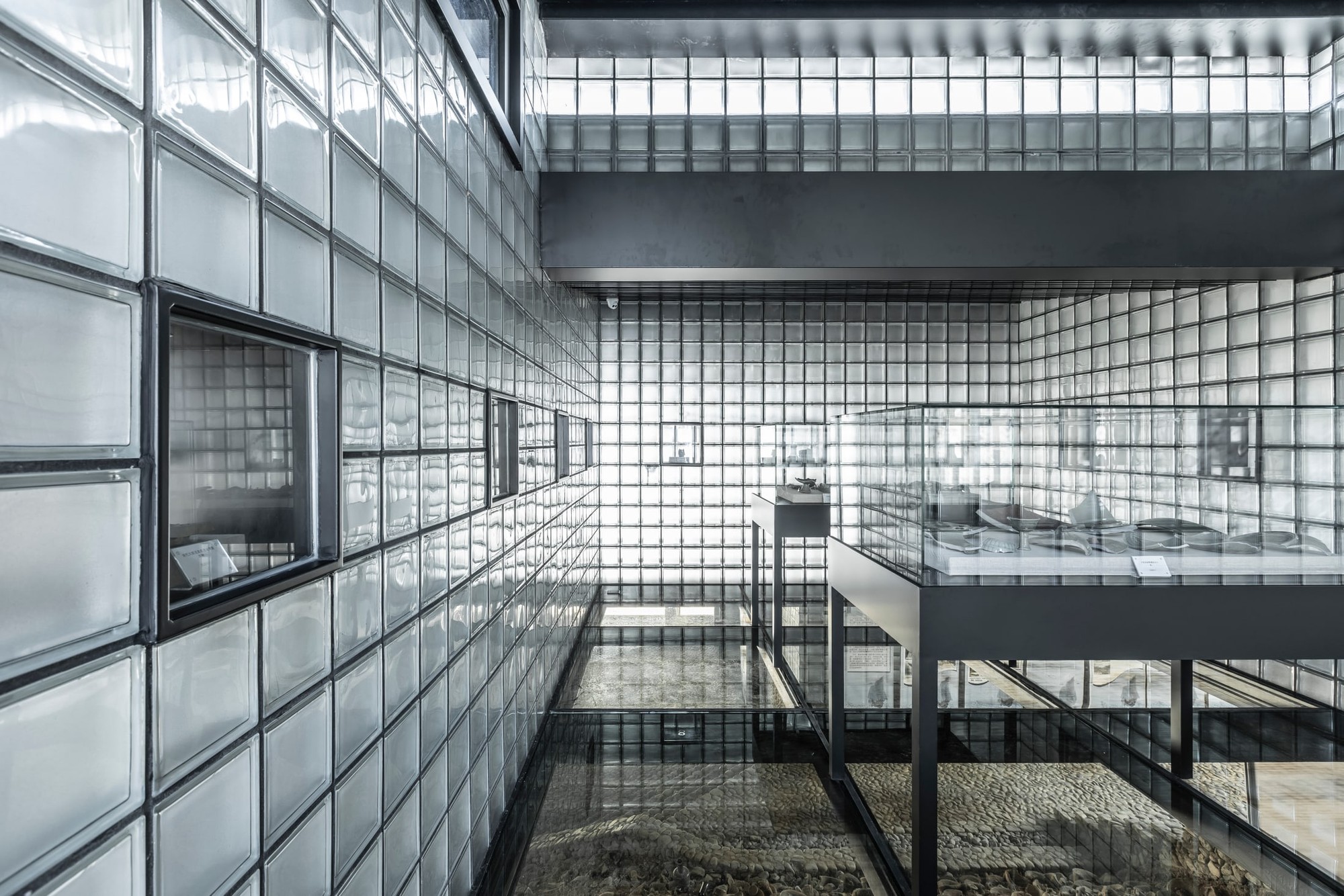 Display cases and glazed floor areas share views of the archaeological remains below.