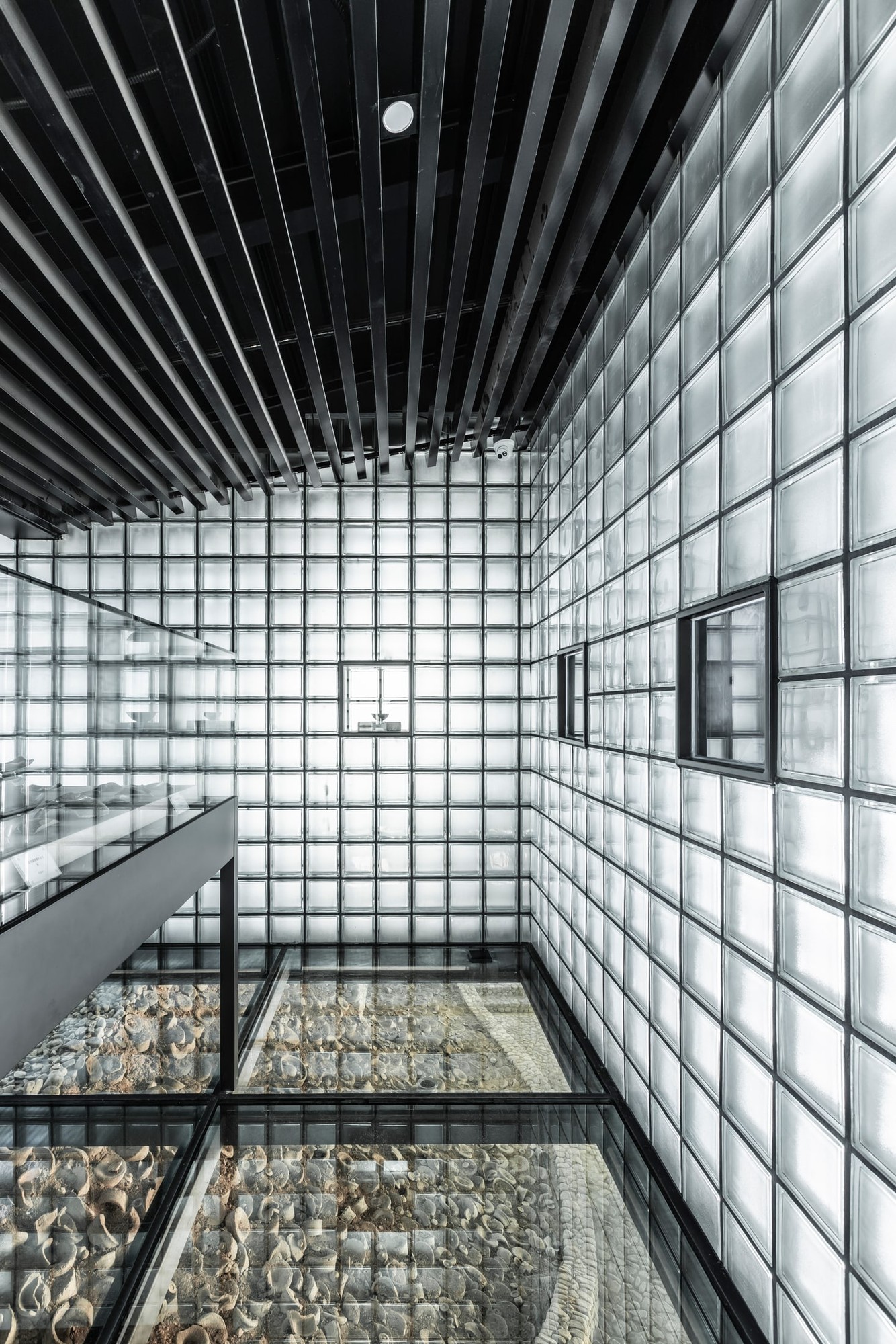 The transparent floor reveals kiln remains beneath the exhibition room.
