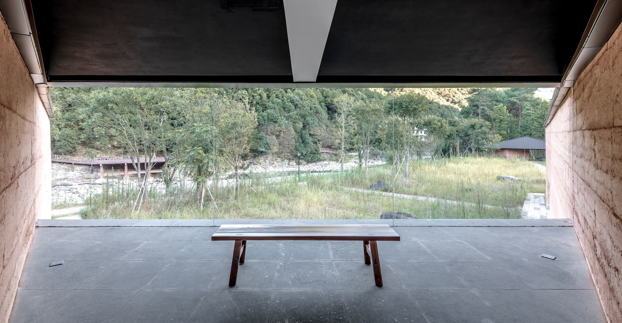 A low bench keeps the view through the glazed opening clear.