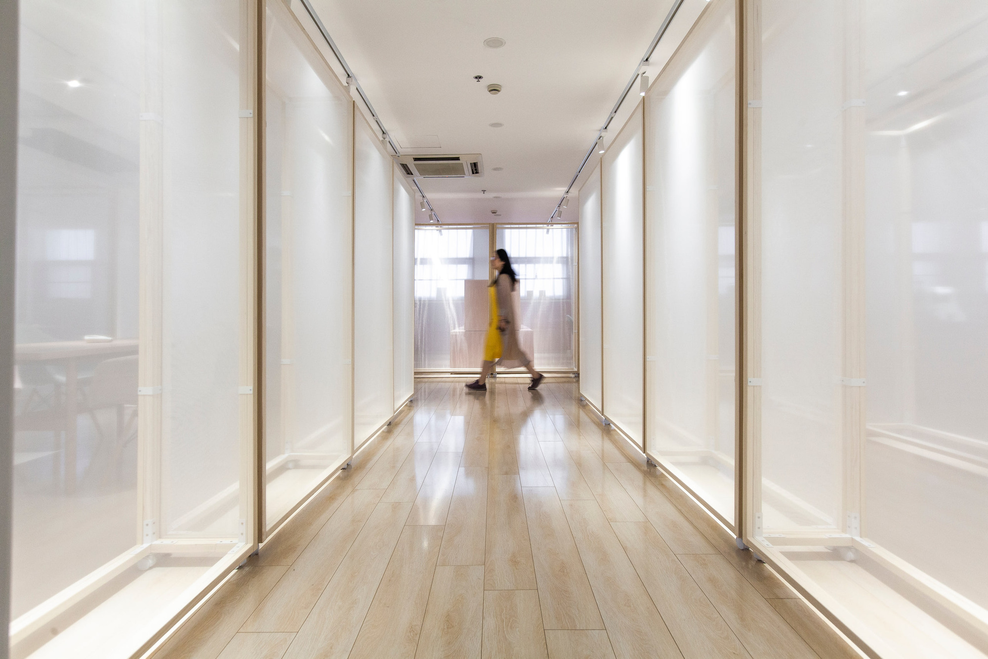 A completed passage formed by translucent display partitions.