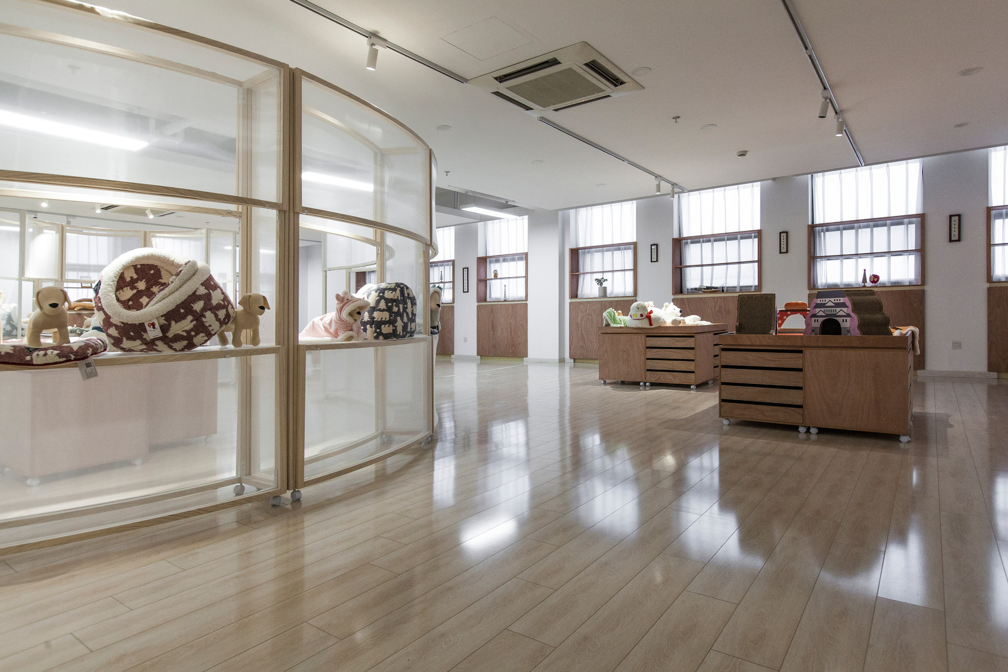 Display furniture is arranged beneath the retained ceiling and lighting infrastructure.