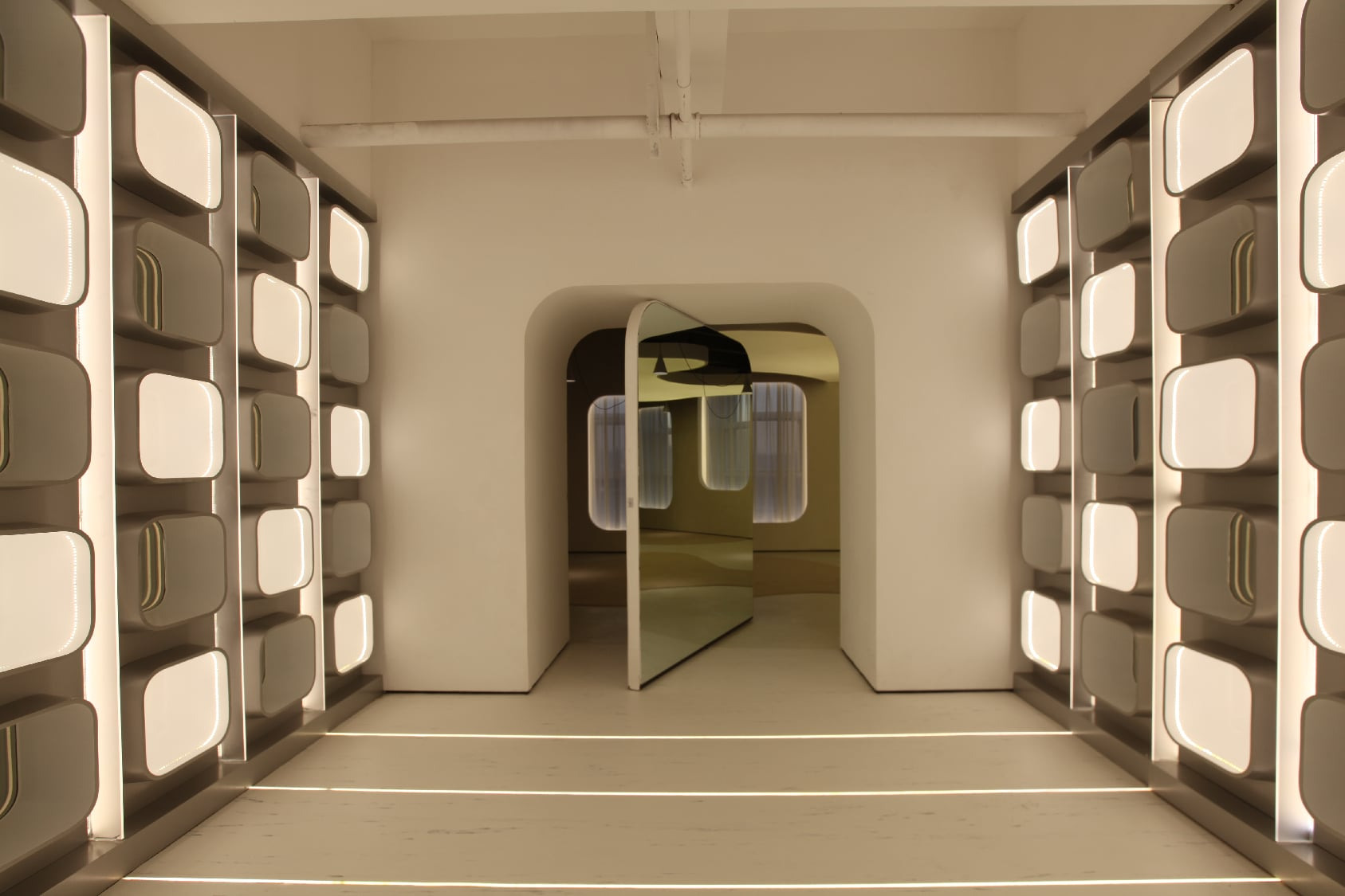 A passage between modular display walls connects to the next room.